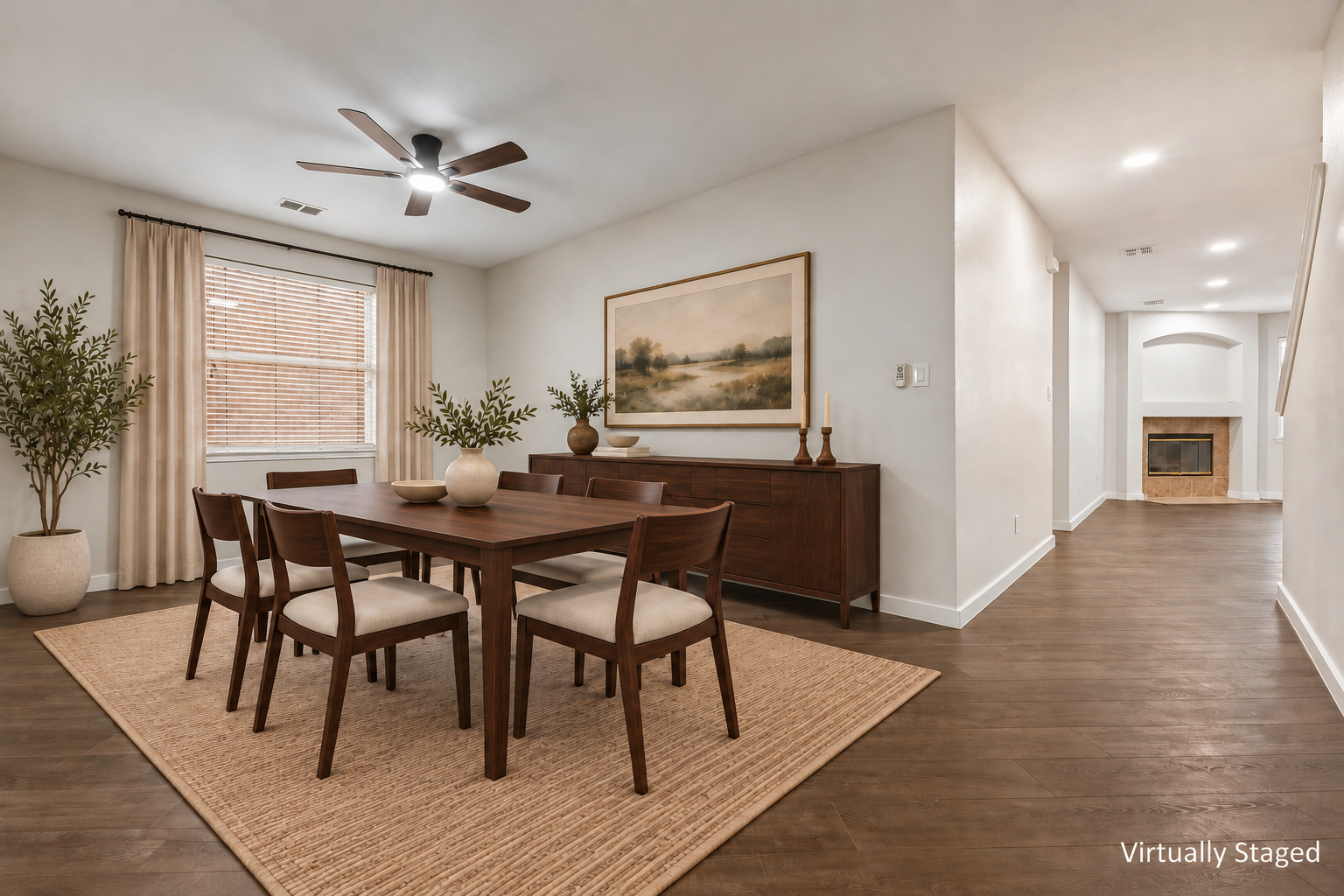 Virtually staged view of the dining area with a view toward the living room fireplace at 4215 Maidstone Drive.