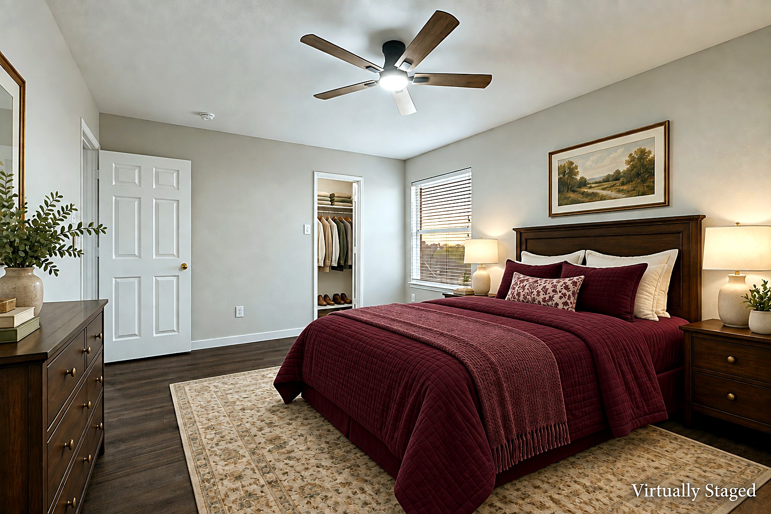 Virtually staged view of a secondary bedroom with burgundy bedding, ceiling fan, and reach-in closet at 4215 Maidstone Drive.