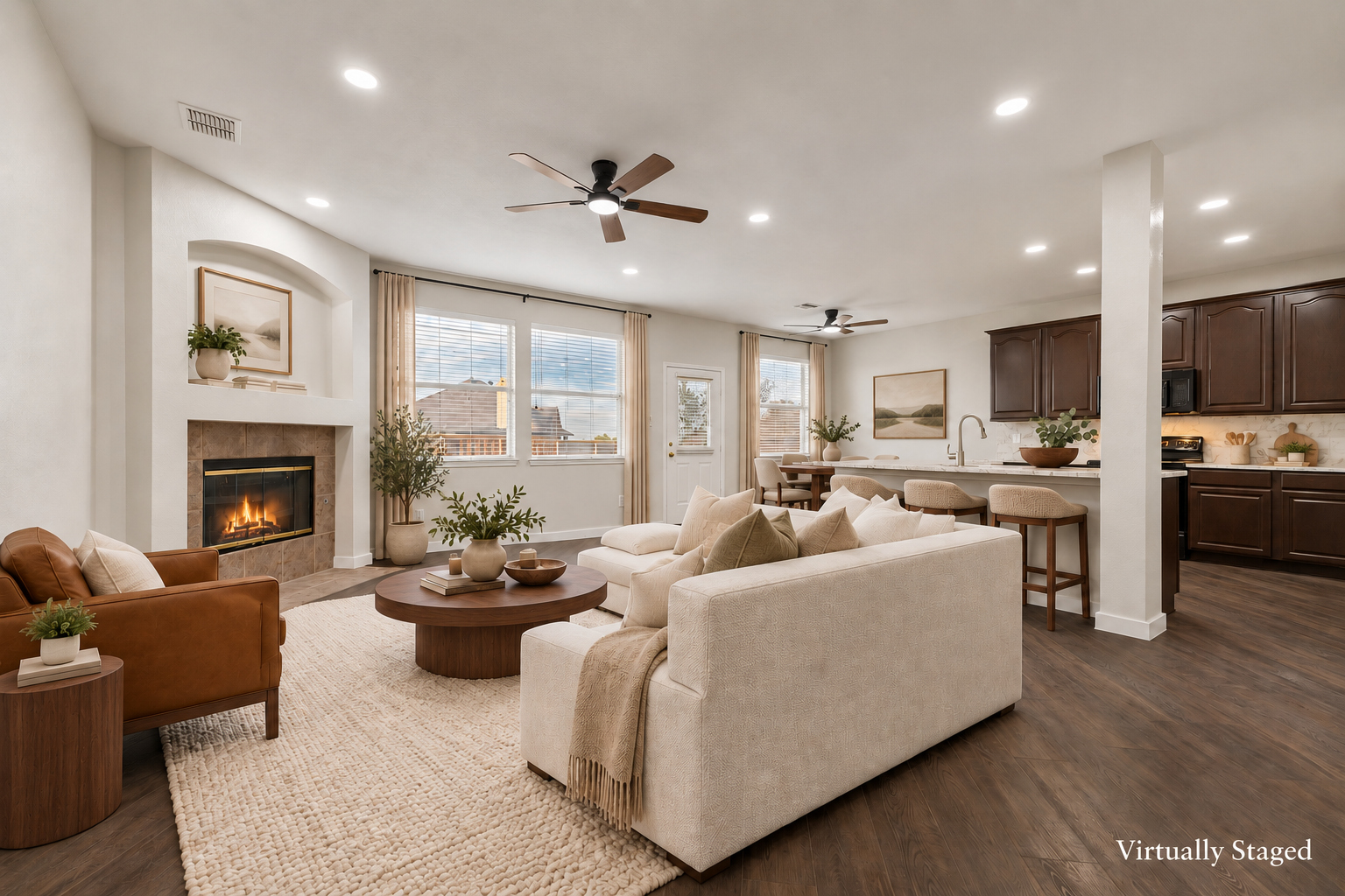 Virtually staged view of the living room with fireplace and casual seating at 4215 Maidstone Drive.