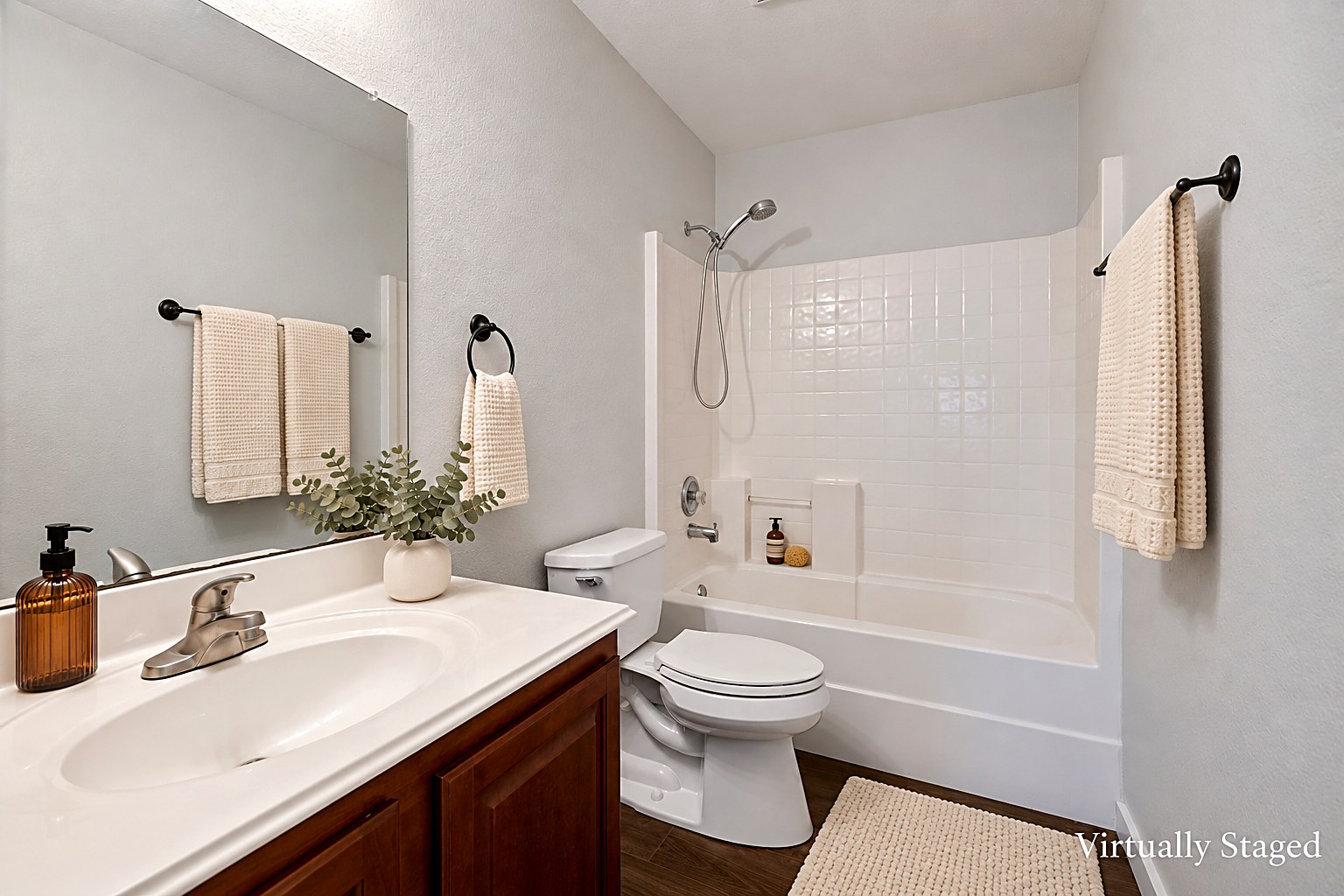 Virtually staged view of a full bathroom with single vanity and tub-shower combination at 4215 Maidstone Drive.