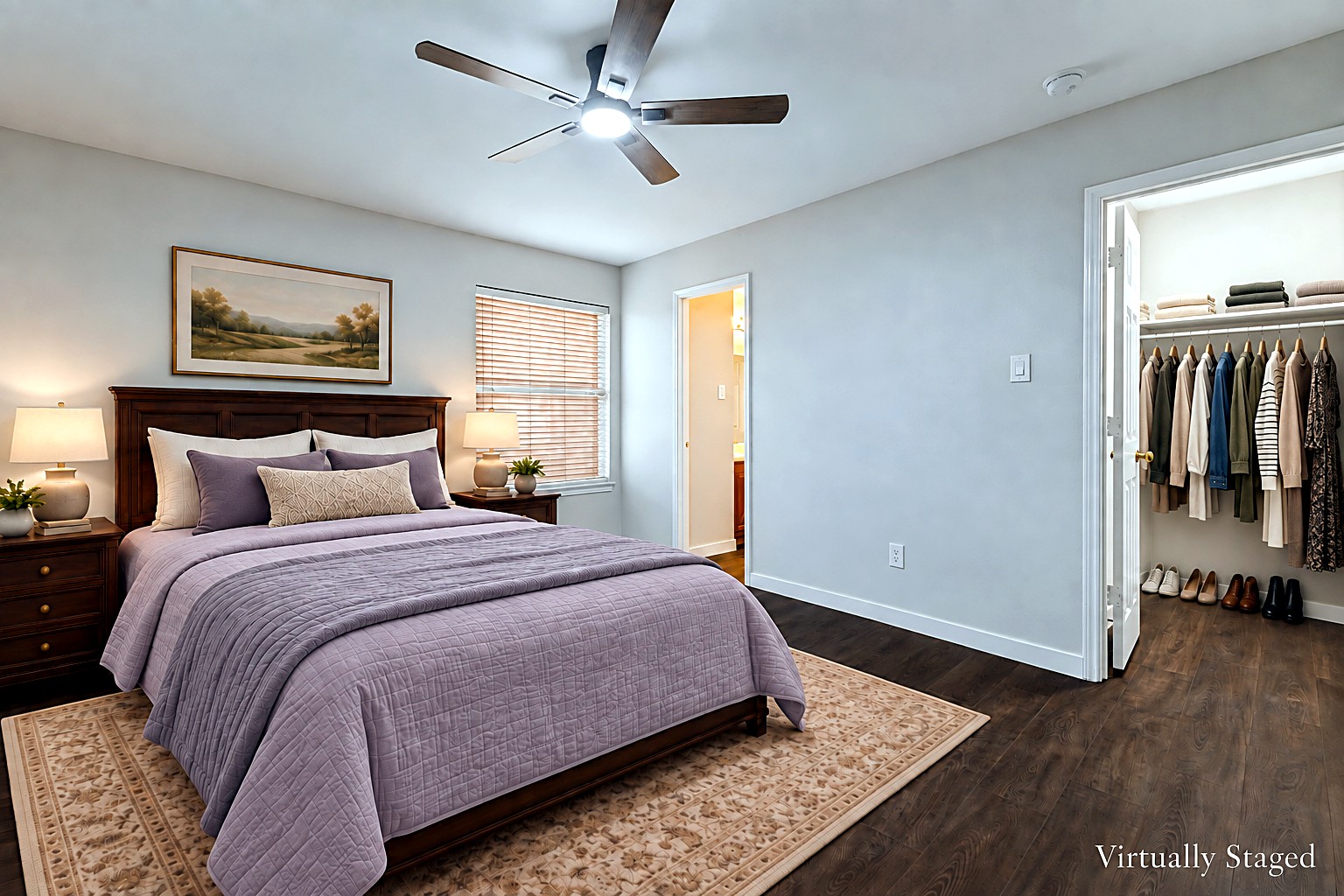 Virtually staged view of a bedroom with lavender bedding, ceiling fan, and walk-in closet at 4215 Maidstone Drive.