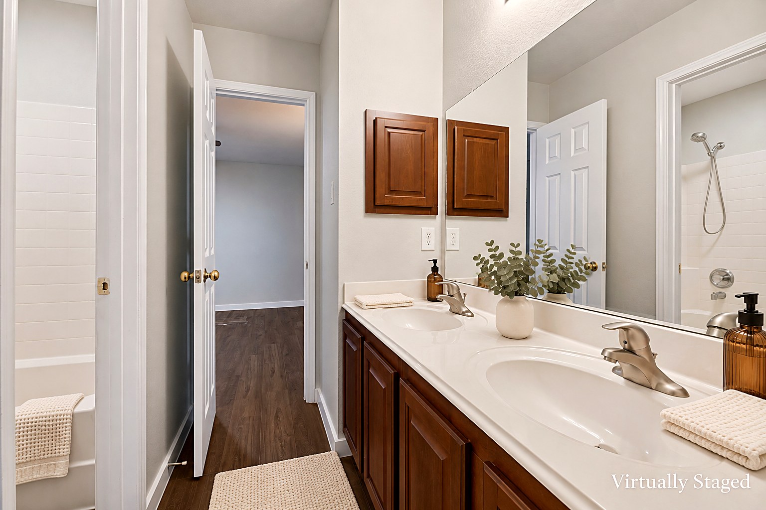 Virtually staged view of a dual-vanity Jack-and-Jill bathroom connecting two bedrooms at 4215 Maidstone Drive.