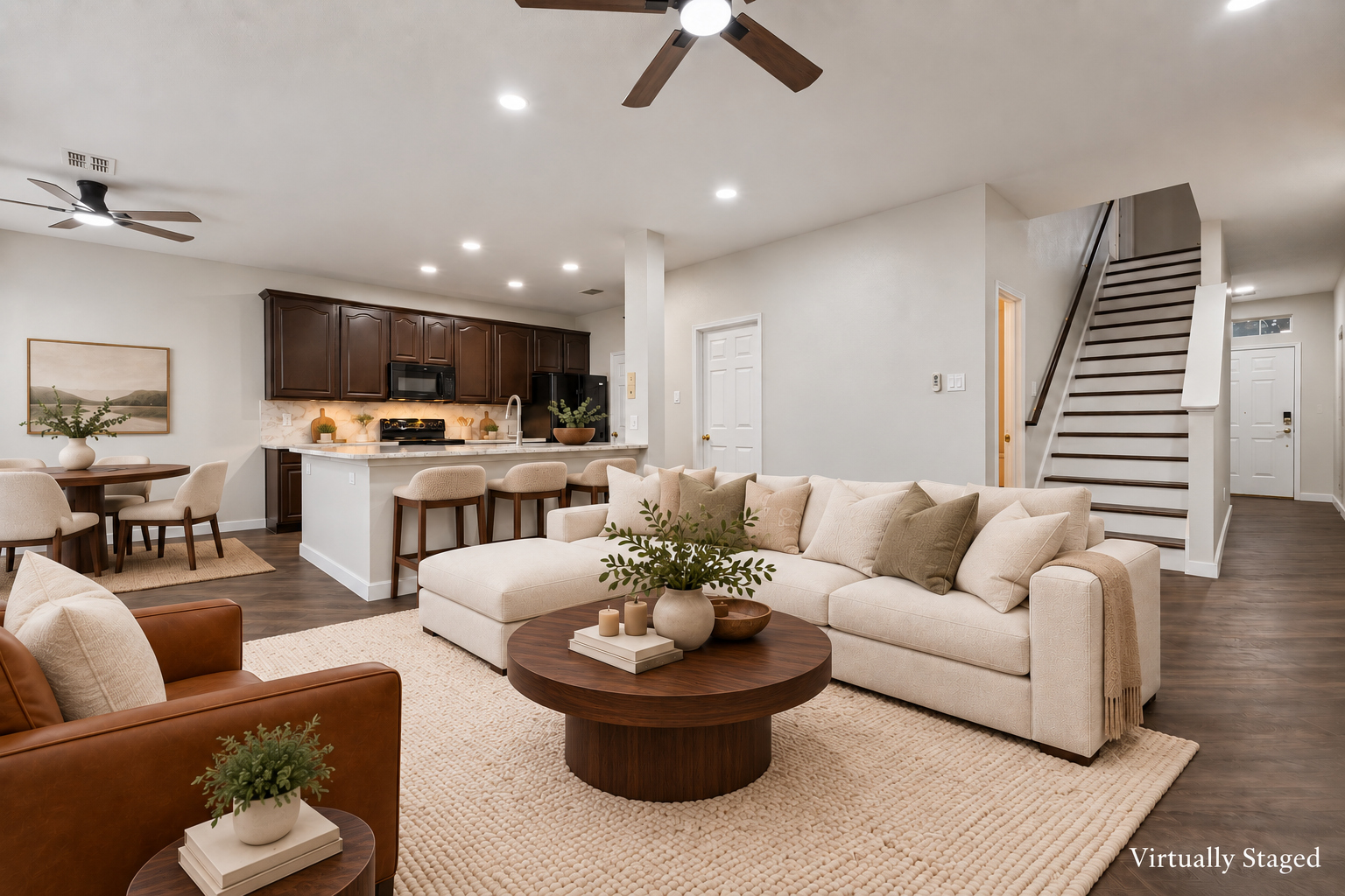Virtually staged view of the two-story great room with staircase at 4215 Maidstone Drive.